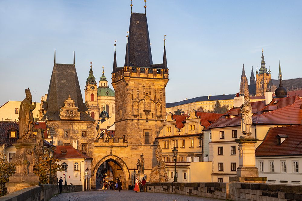 Arch of Lesser Town Bridge Tower on Charles Bridge with St. Nicholas Church in Prague.
